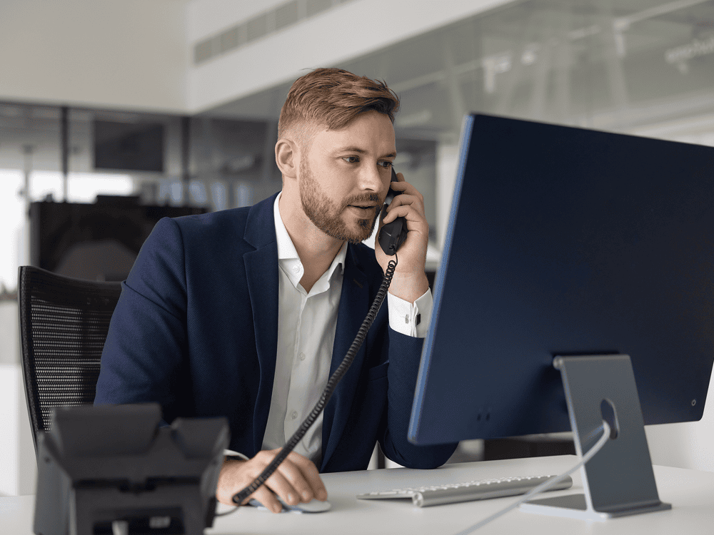 Man in office talking on the phone.