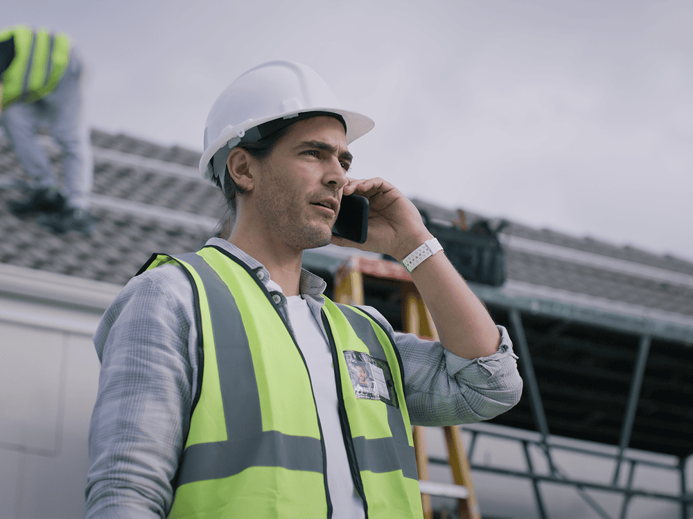 Construction worker talking on the phone.